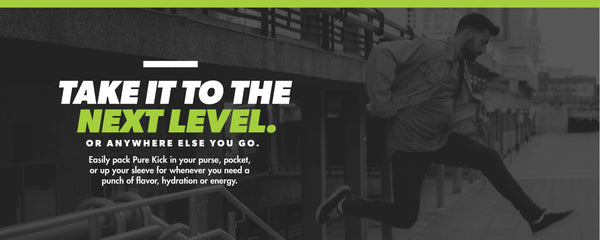 Take it to the next level, Promotional banner featuring a man running up stairs in an urban setting, monochrome with green accents. The slogan 'TAKE IT TO THE NEXT LEVEL. OR ANYWHERE ELSE YOU GO.' is displayed in bold, white and green letters. The text promotes the portability of Pure Kick, suggesting it can be taken in a purse, pocket, or sleeve for a boost of flavor, hydration, or energy
